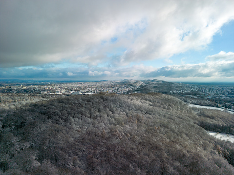 Aerial view from the top of snow-covered mountain pine trees and trees in snowy winter. tree tops in white snow. High quality photo