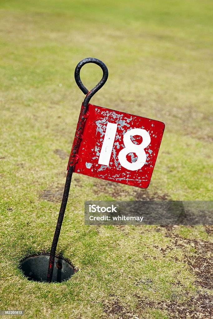 No 18 - flag in hole on putting green The eighteenth and final hole on a putting green.More seaside activities from my portfolio. Please see my lightboxes for more. Bright Stock Photo