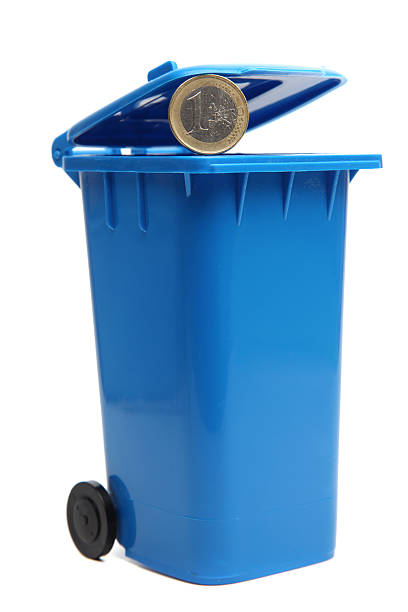 istock Euro coin, going into blue recycling bin. 182201852