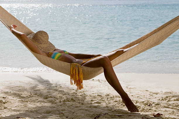 istock woman napping in hammock at the beach 182202624