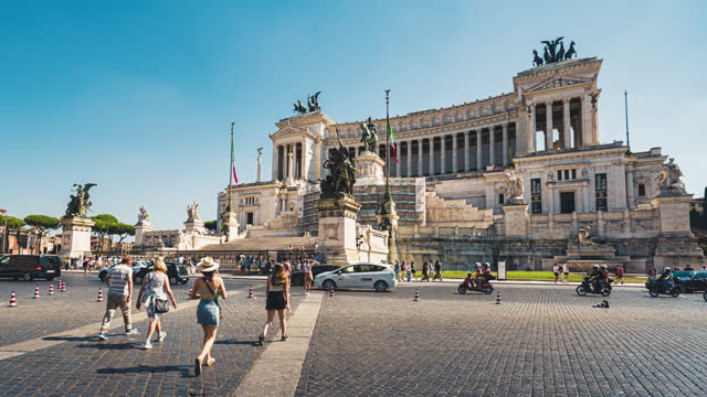 Time lapse of Crowd of People tourist walking and crossing street at Monument to Victor Emmanuel II historical landmark with traffic jam car in summer in Rome, Italy
