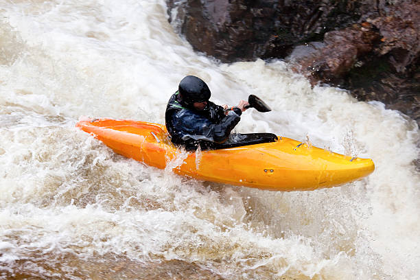 istock Kayaker paddles over the top of falls 182203940