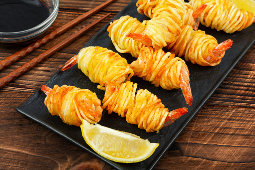 Fried rolled potato shrimps, prawns and potato rolls. Popular Asian food. Vietnamese cuisine.