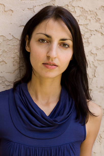 istock Young attractive female model against stone wall 182204438