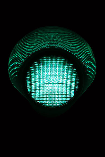 Green light Green single traffic light in the night. Other traffic lights in: green light stoplight photos stock pictures, royalty-free photos & images