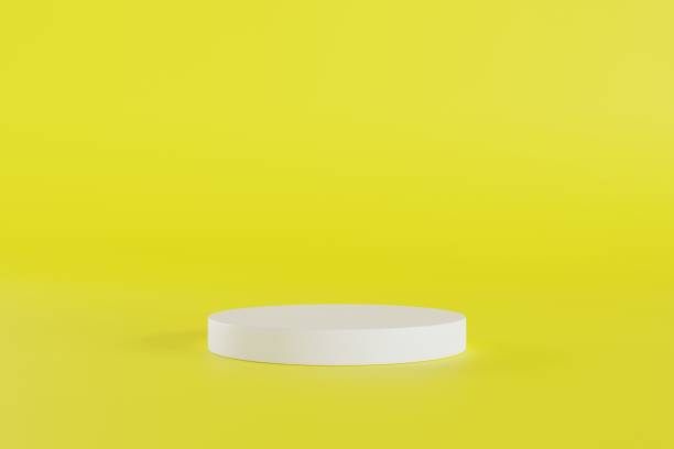 istock 3D white cylinder podium show products on yellow background. 3d render illustration. 1822050254