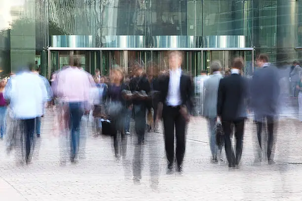 Photo of Business people walking in front of  an office building
