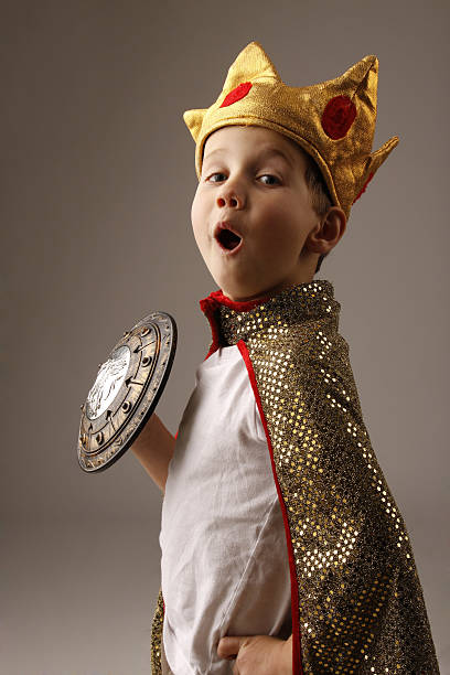 Young boy in costume of a king with crown stock photo
