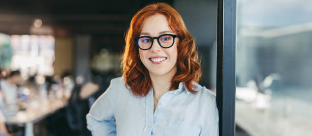istock Successful female entrepreneur standing in panoramic office, smiling with professional confidence 1822057694