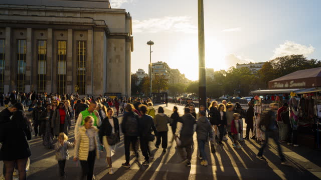 Time lapse Crowd of People tourism pedestrian walking and sightseeing city street around Palais de Chaillot and Trocadero Square at sunset time in Paris in summer, France