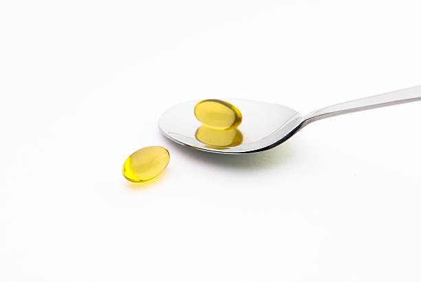 Omega 3 Omega 3 cod liver oil fish oil vitamin a pill stock pictures, royalty-free photos & images