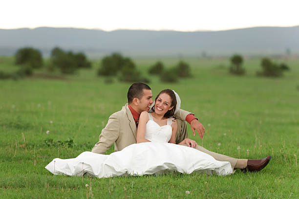 Follow me, follow me, marry.  Beautiful young woman bride holds the hand of a man in outdoors. Bride is the groom's hand. To go forward together. Bride and groom, who goes ahead. Just married.