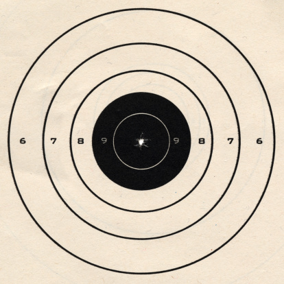 Official 25 feet rapid fire pistol target with bulls-eye bullet hole.