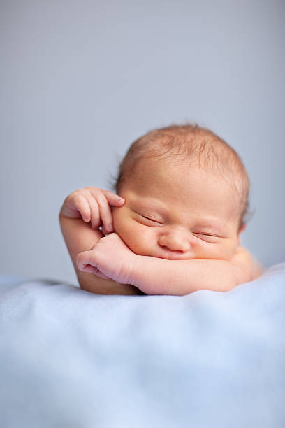 istock Newborn Baby Boy Sleeping Peacefully on Blue Blanket 182208798