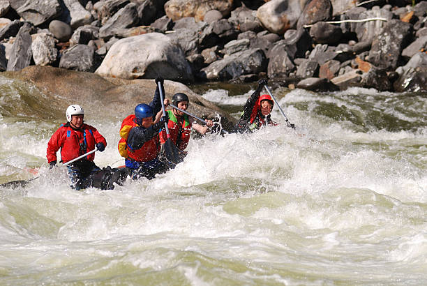 cuatro de los deportistas flotan sobre el río de montaña peligrosas - team sport rafting white water rafting rapid fotografías e imágenes de stock