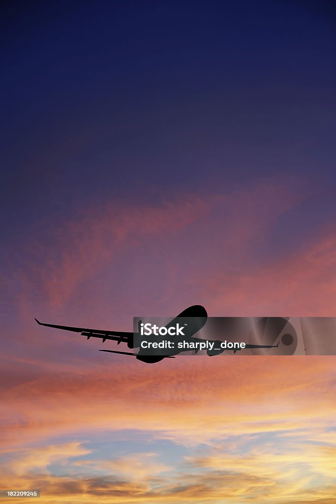 XXXL jet airplane taking off at sunset "jet airplane in silhouette taking off at sunset, vertical frame (XXXL)" Airplane Stock Photo