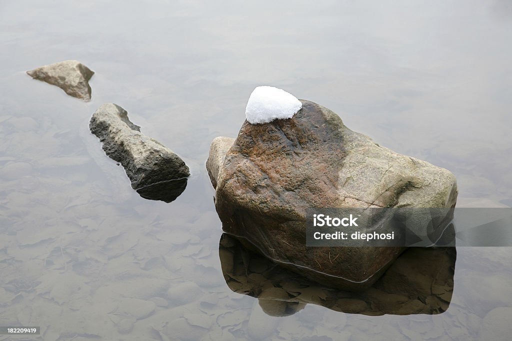 three stones three stones lying in shallow water Arrangement Stock Photo