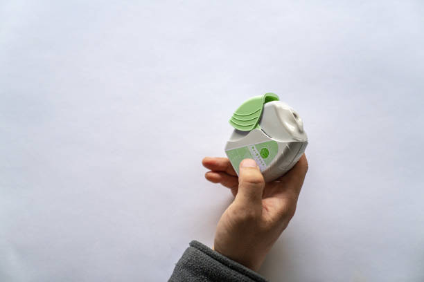 girl using  inhaler at outdoor