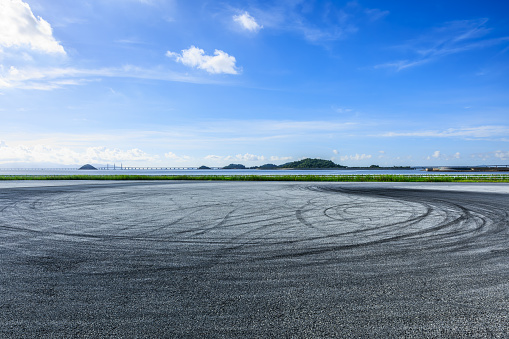 Race track road and coastline landscape under blue sky