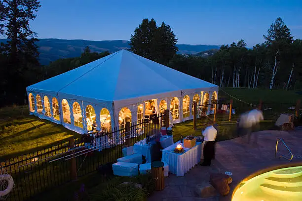 Party Tent Glowing Warm at Dusk with Cool Blue Light.  Entertainment catering tent at party event.  Converted from 14-bit Raw file.  sRGB color space.