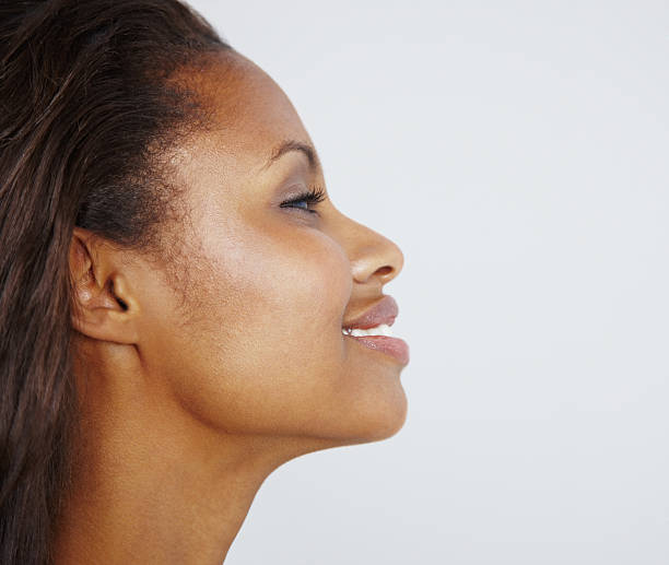 istock Side profile of a beautiful young woman smiling 182210534