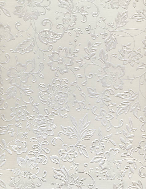 Embossed floral design of a wedding pattern ivory fabric texture brocade stock pictures, royalty-free photos & images