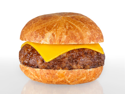 An angus beef burger shot from above on a white background.