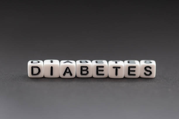 istock The name diabetes created by white beads on a gray background. 1822111725