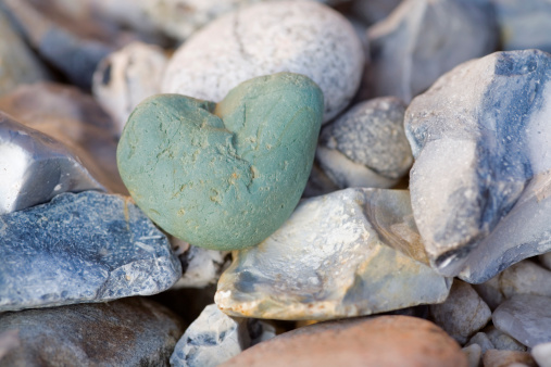 a heart-shaped stone is located between many other stones