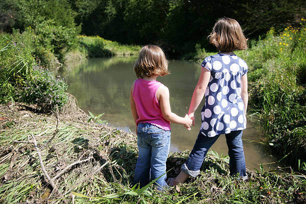 child  and toddler, sisters, catching bubbles in the garden
