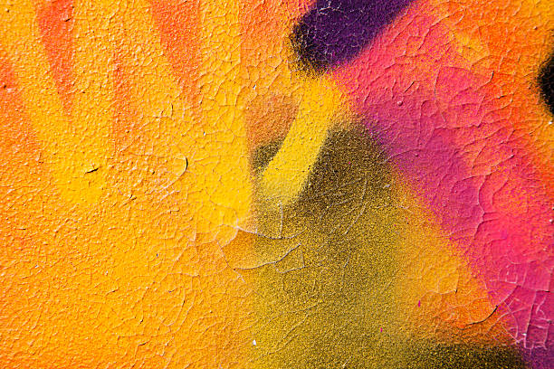 Colorful graffiti over a cracked surface Close up of graffiti on wall of abandoned building. art stock pictures, royalty-free photos & images