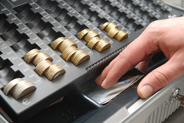 istock cash register - hand taking money 182213517