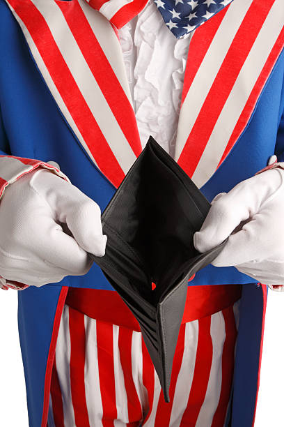 Government Spending Uncle Sam holding an empty wallet.. uncle sam broke stock pictures, royalty-free photos & images
