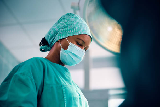 istock Black female surgeon during procedure in operating room. 1822147160