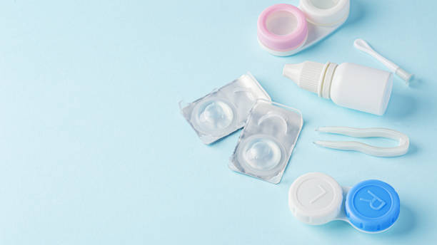 istock Contact lenses with container, eye drop and tweezer on blue background 1822147671