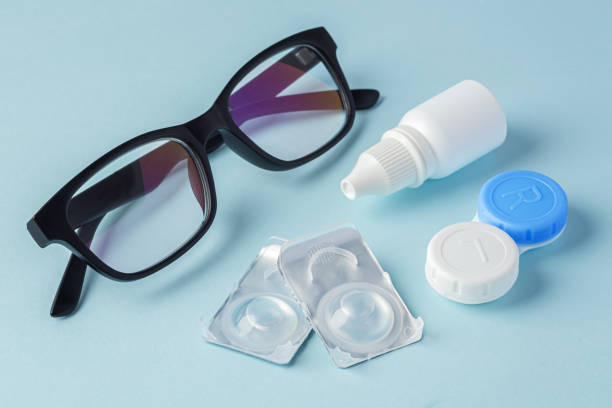 istock Eyeglasses and contact lenses with container on blue background 1822148747