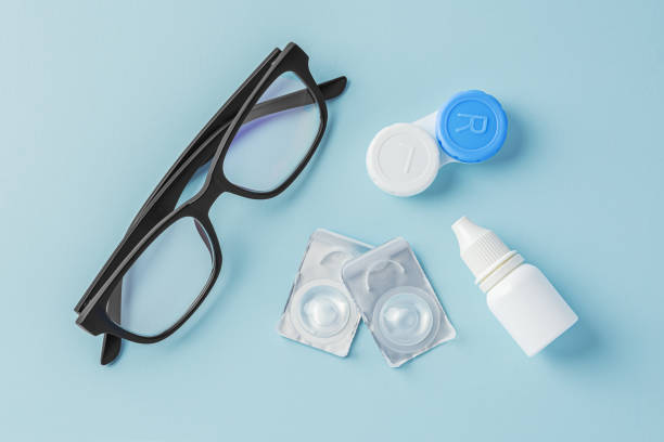 istock Eyeglasses and contact lenses with container on blue background 1822148767