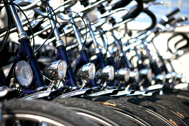 Front part of some bicycles parked in a row: detail "Front part of some bicycles parked in a row: detail, extreme DOF" bicycle light photos stock pictures, royalty-free photos & images