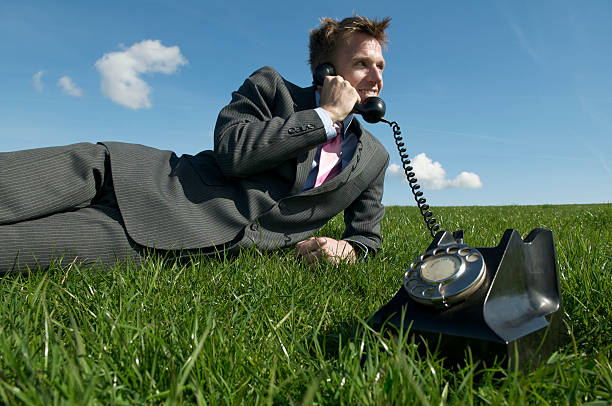 istock Young Man Businessman Talking on Telephone Green Grass 182215310