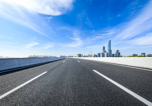 istock Asphalt road and city skyline under blue sky 1822156418