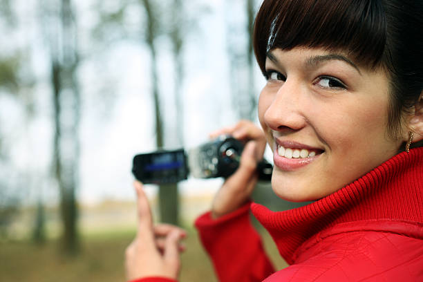 istock woman with a digital video camera 182216336