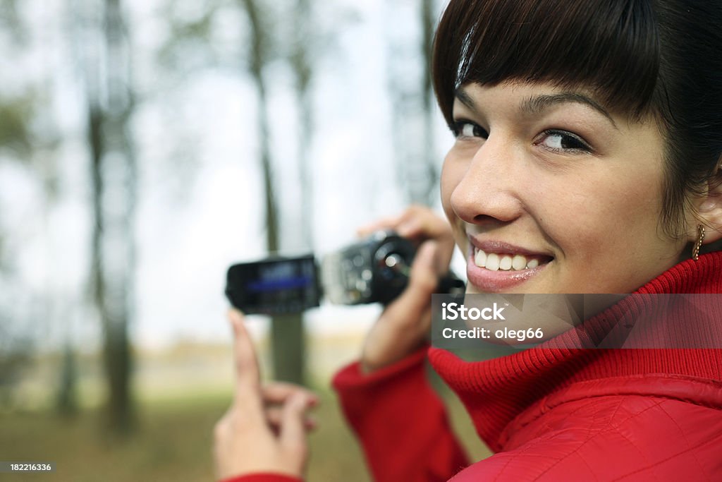 woman with a digital video camera Adult Stock Photo