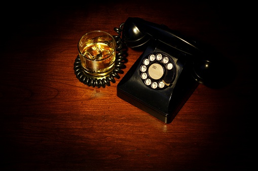 A scotch on the rocks and a 1940s style telephone.