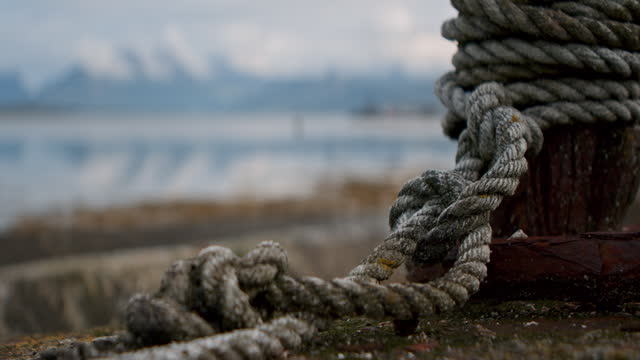 Close-Up Of Rope On Lakeside Post