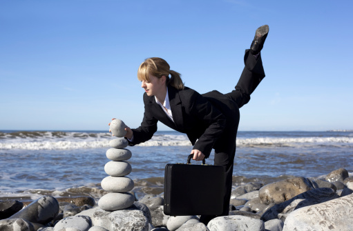 office worker/business person does balancing act
