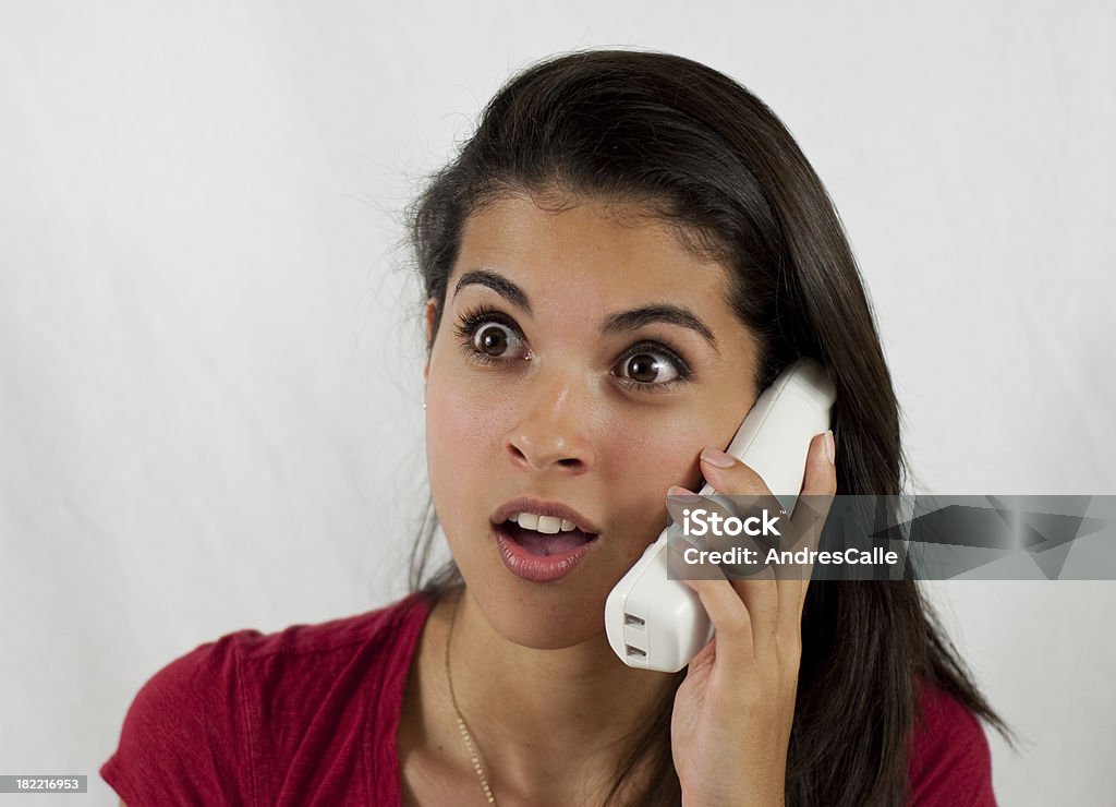 Woman talking on the phone Surprising News 18-19 Years Stock Photo