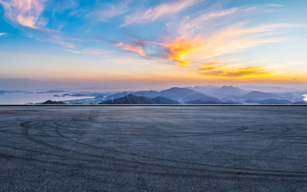 istock Asphalt road square and mountains with colorful sky clouds at sunset. 1822171565