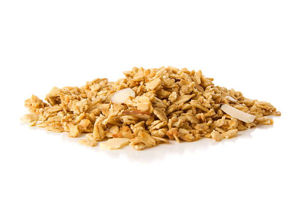 Pile of granola cereal with almonds on white