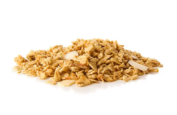 Pile of granola cereal with almonds isolated on white background. Please see my LIGHTBOXES for additional related images:
