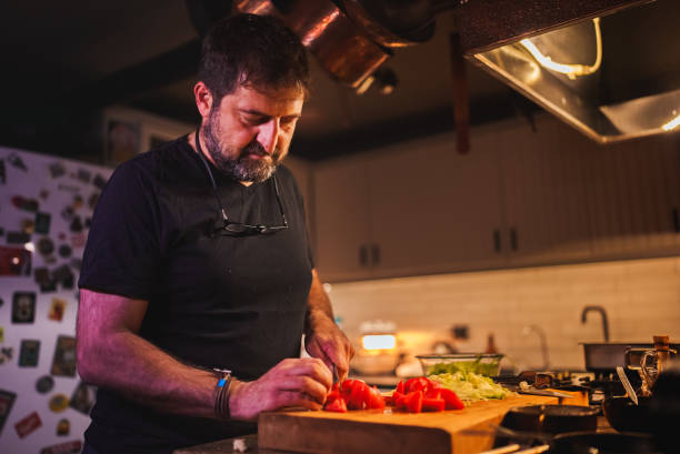 istock Man chopping tomato on board with knife 1822177357